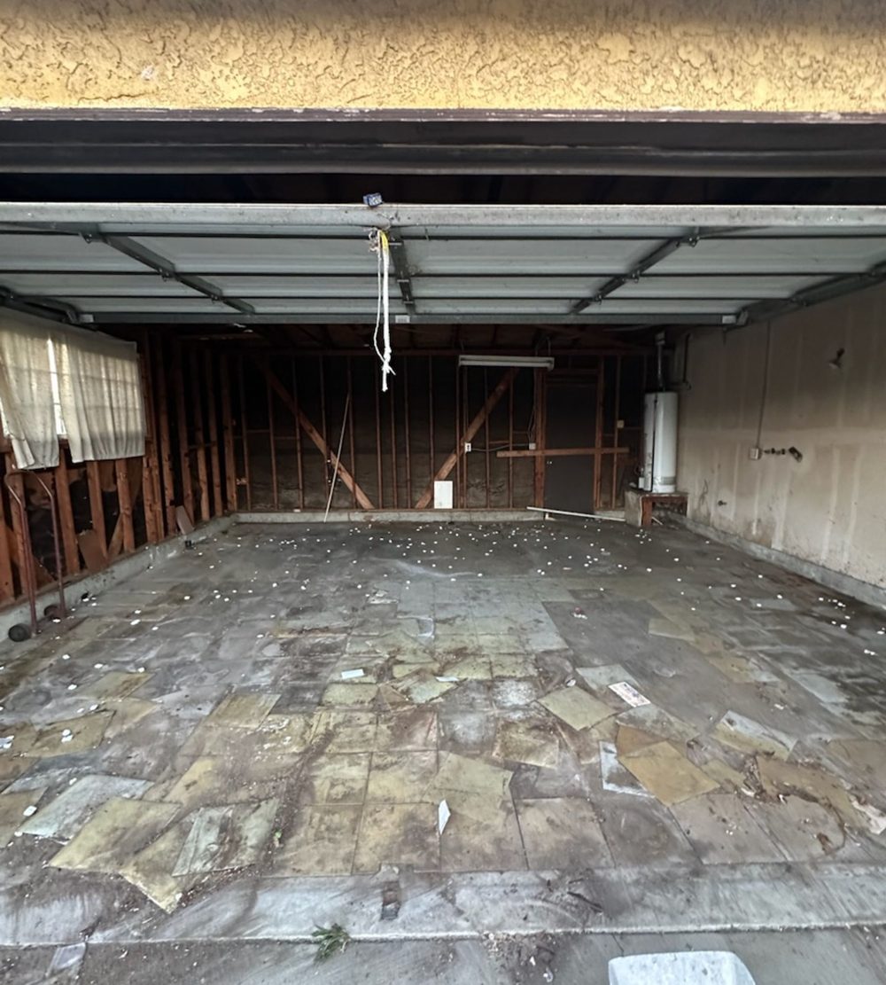Garage floor swept clear after everything was hauled away