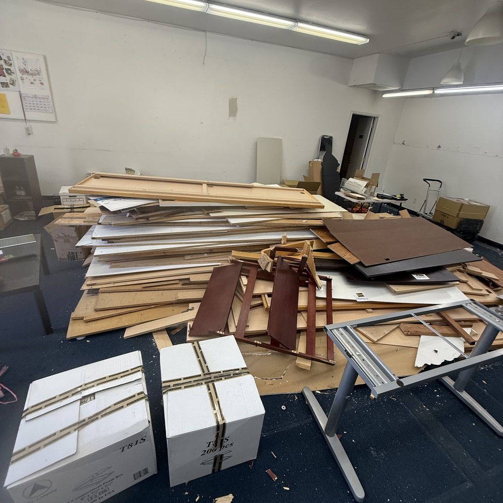 Office cleanout with old desks, boxes and debris to be removed