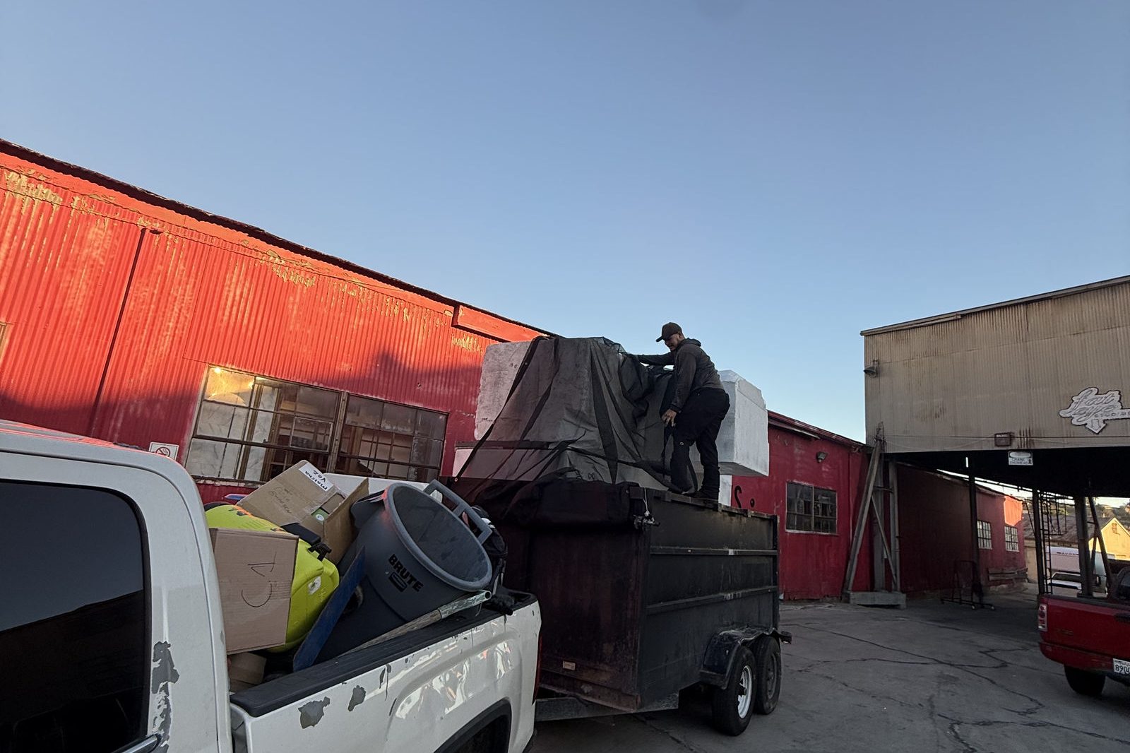 Roa Solution pickup and trailer loaded with junk at the end of a job