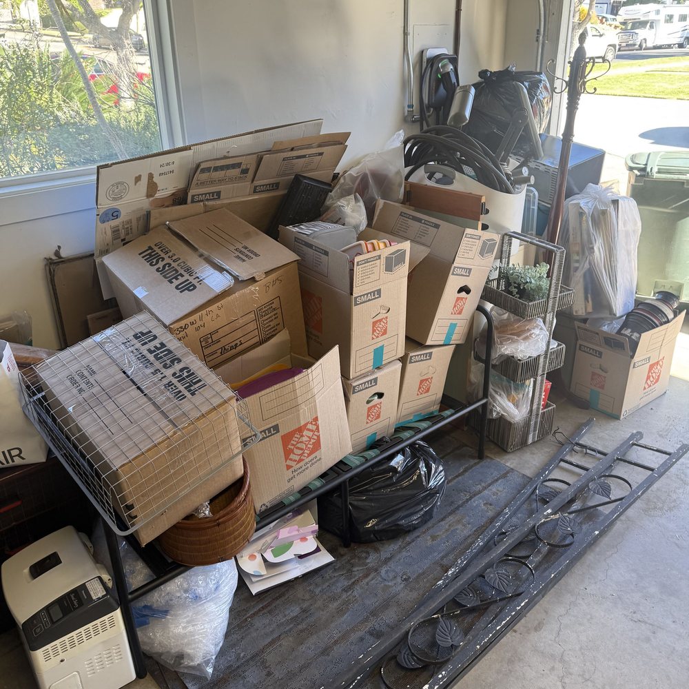 Garage packed with boxes and shelves before an estate cleanout