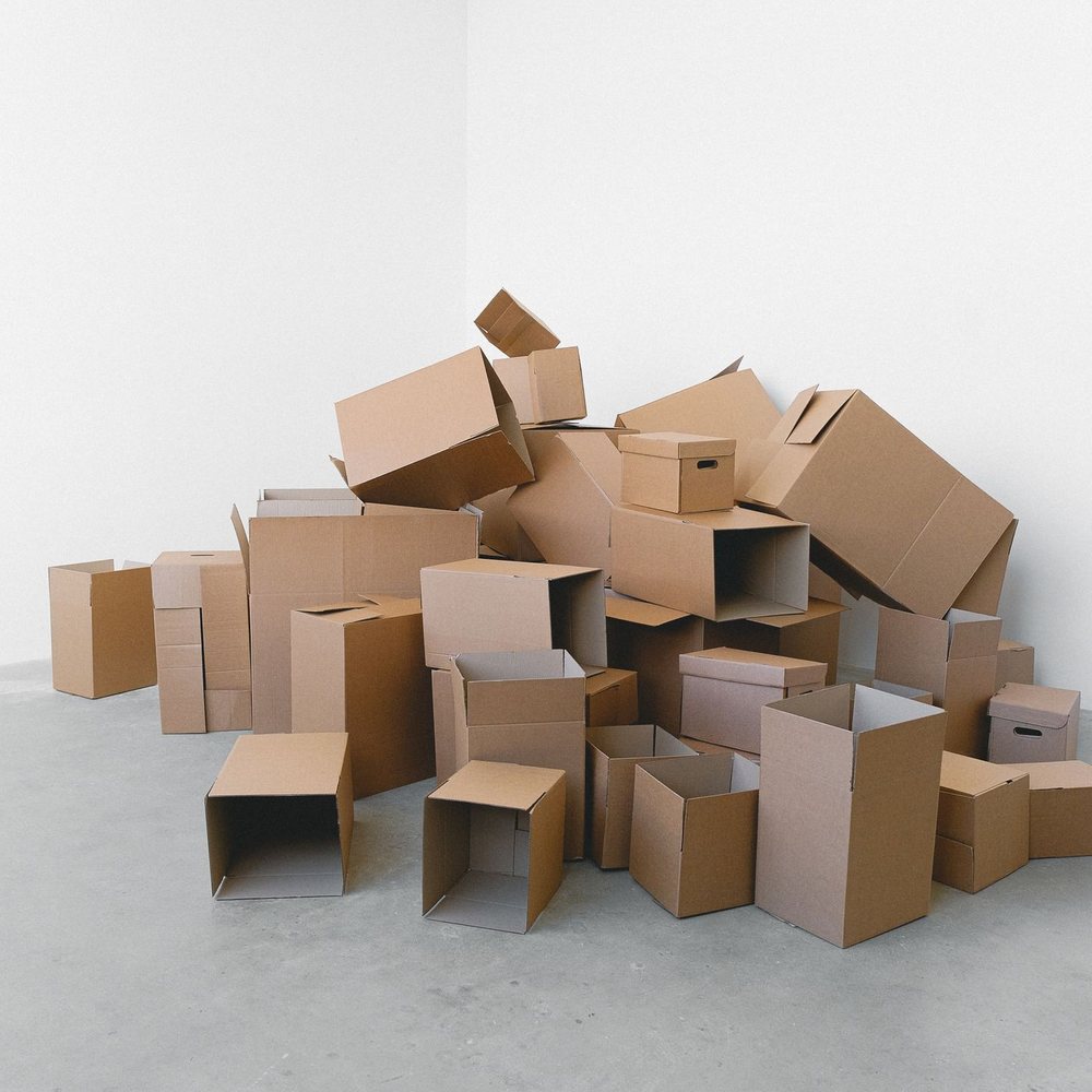 Stack of empty cardboard boxes in an empty room
